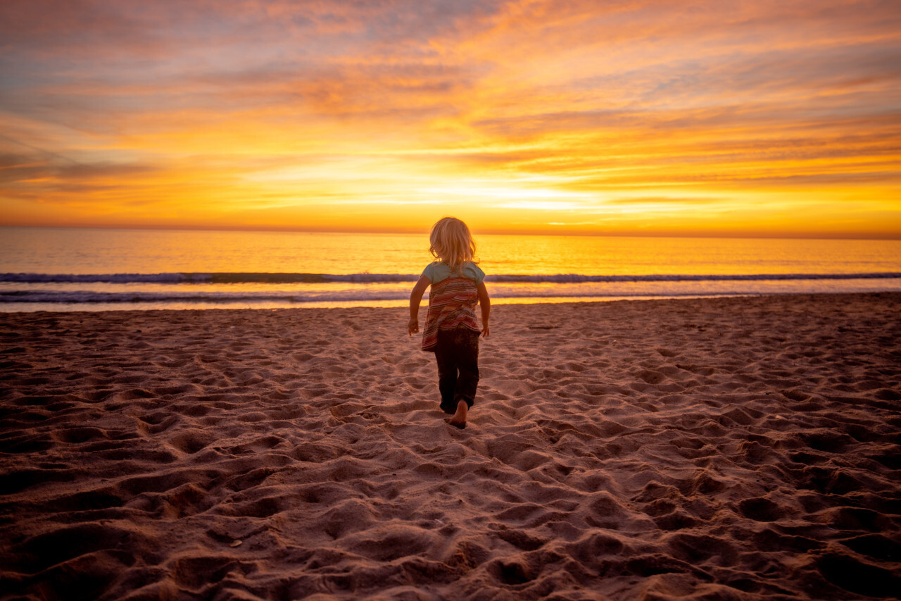 Little blonde girl on the beach at sunset - Portugal Algarve