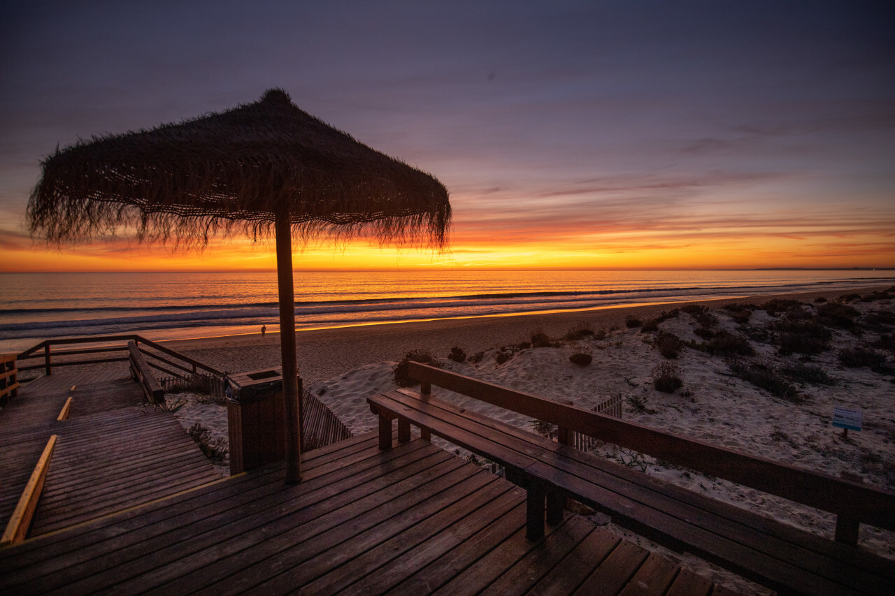 Parasol on the beach in Portugal at sunset