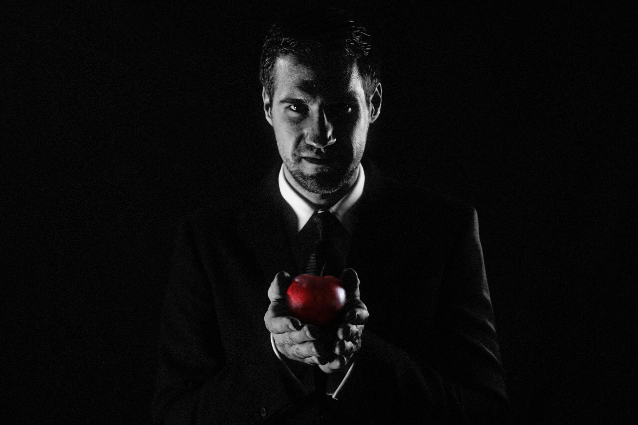 Businessman holds red apple in hand