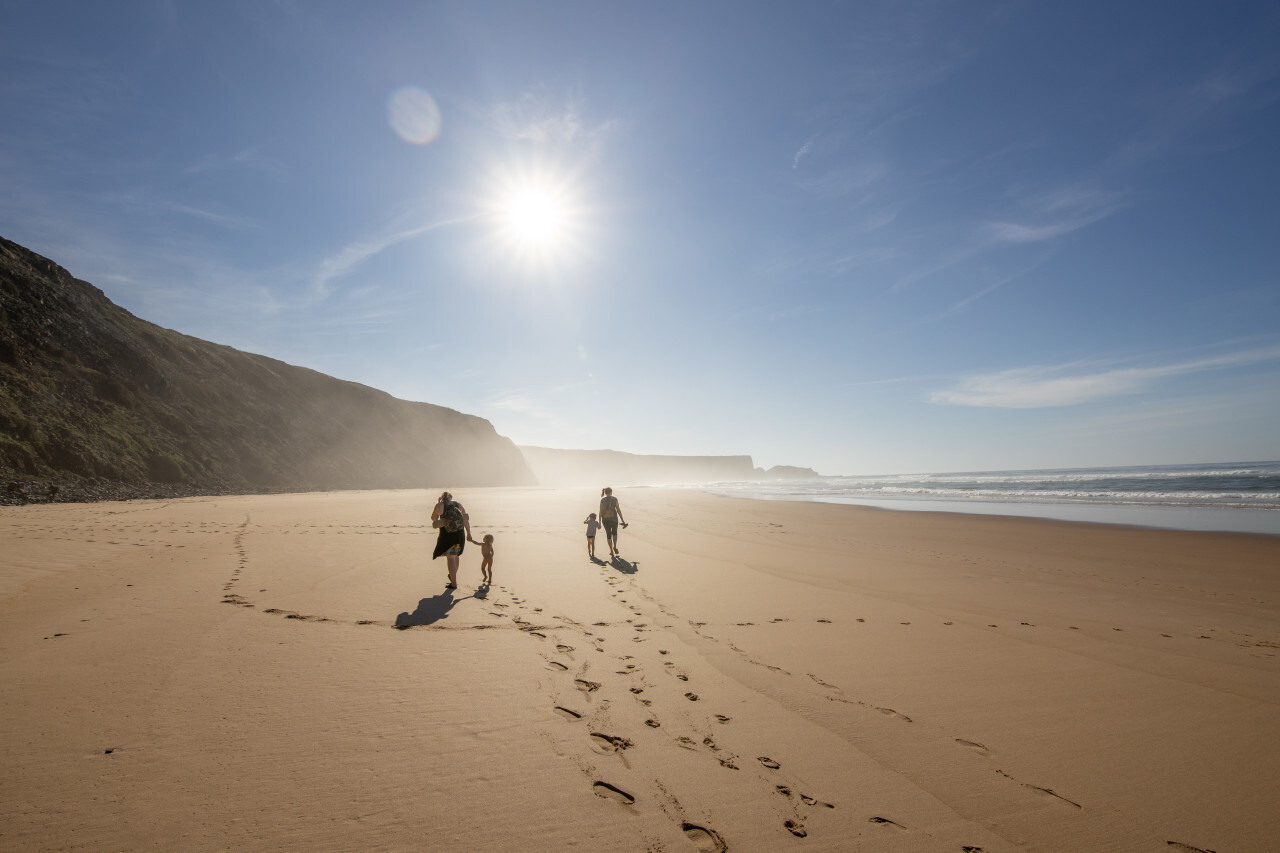 Family walks on the beach in Portugal