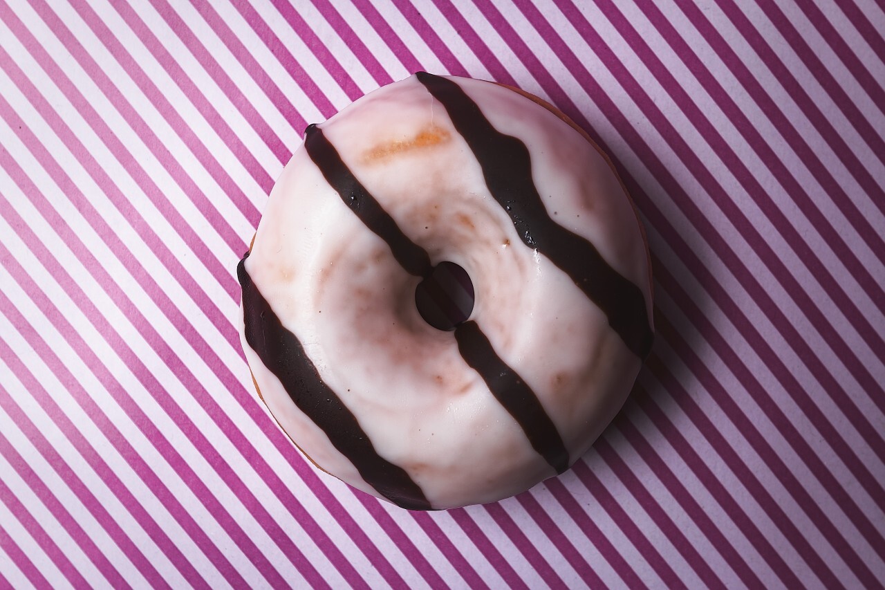 zebra pattern donut on pink striped background