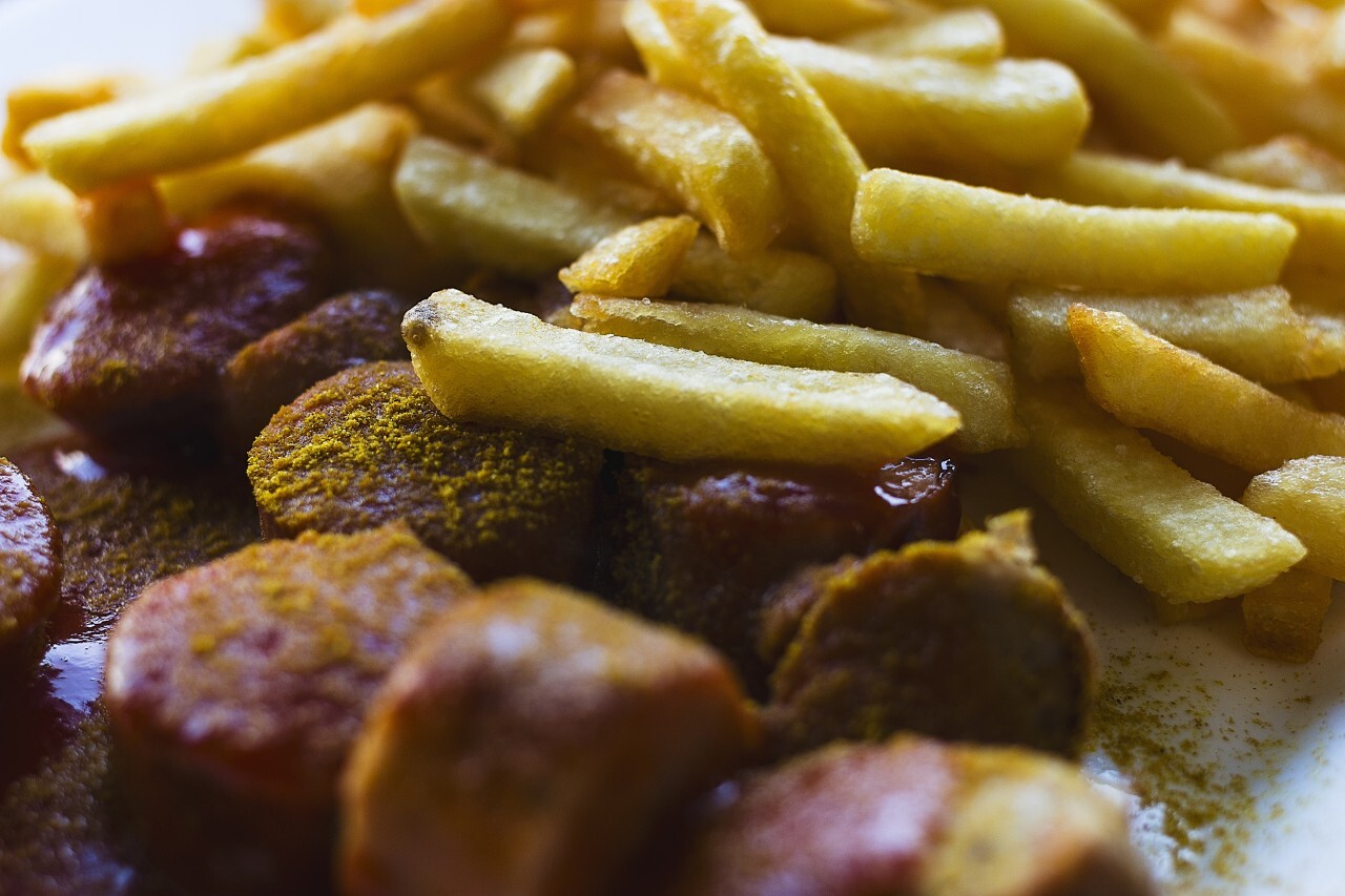 Traditional German currywurst - pieces of sausage with curry sauce