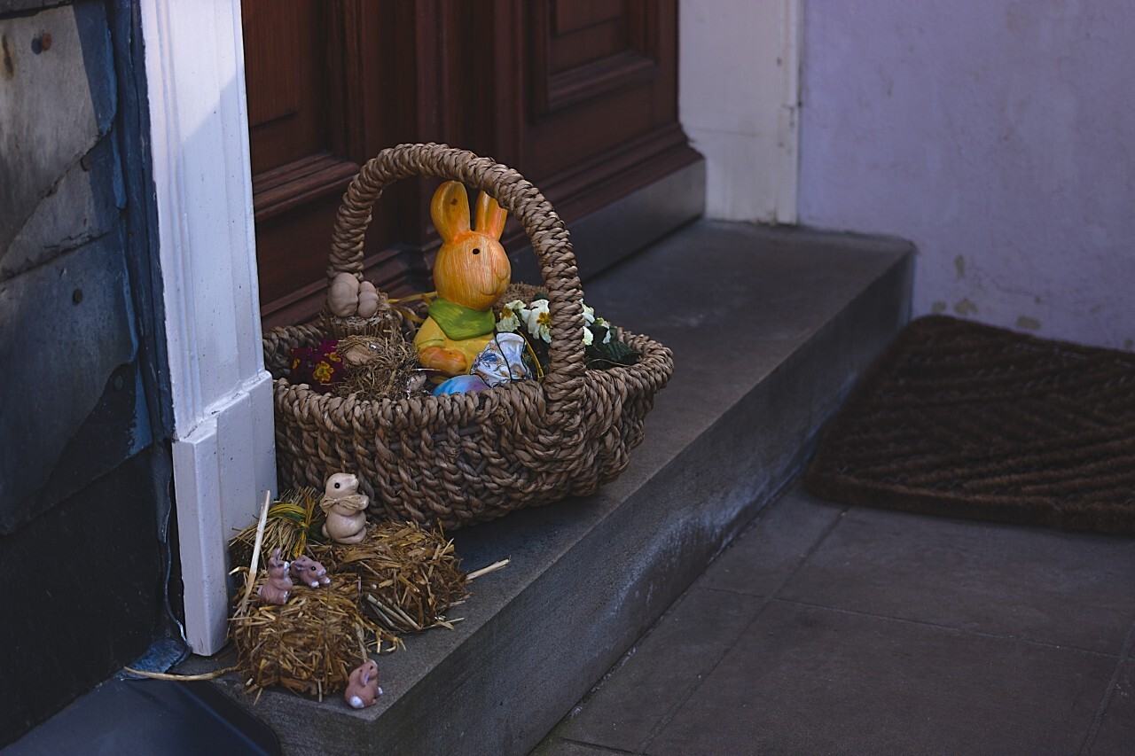Basket filled with Easter decorations on a doorstep