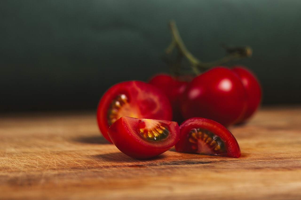 tomatoes sliced on a wooden board