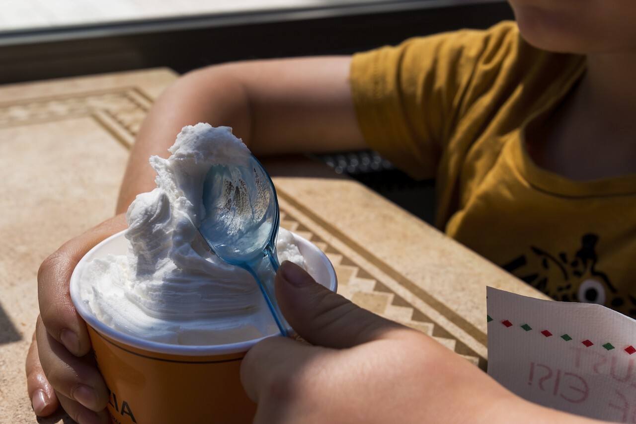 Little toddler eating ice cream summer