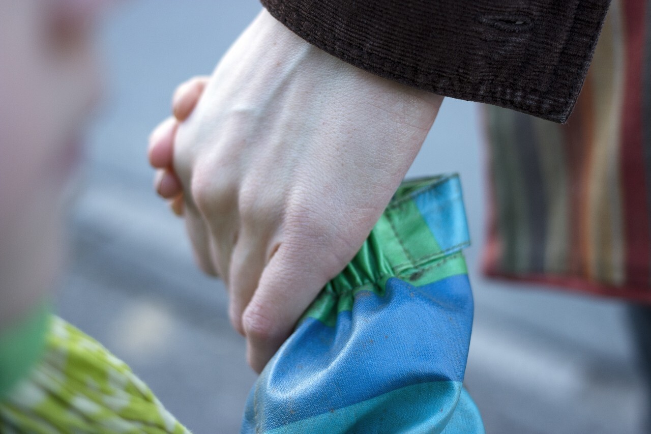 Child holding mother's hand