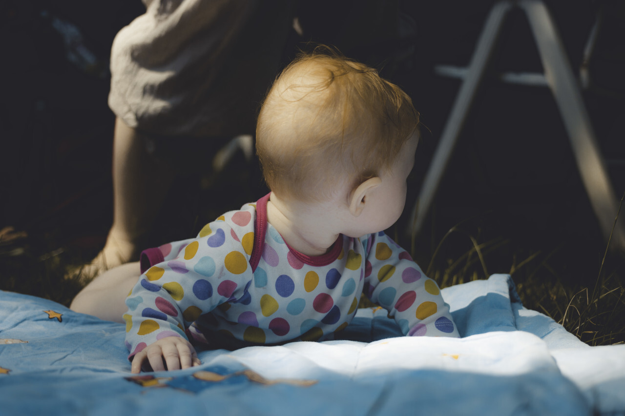 baby on a blanket in the garden