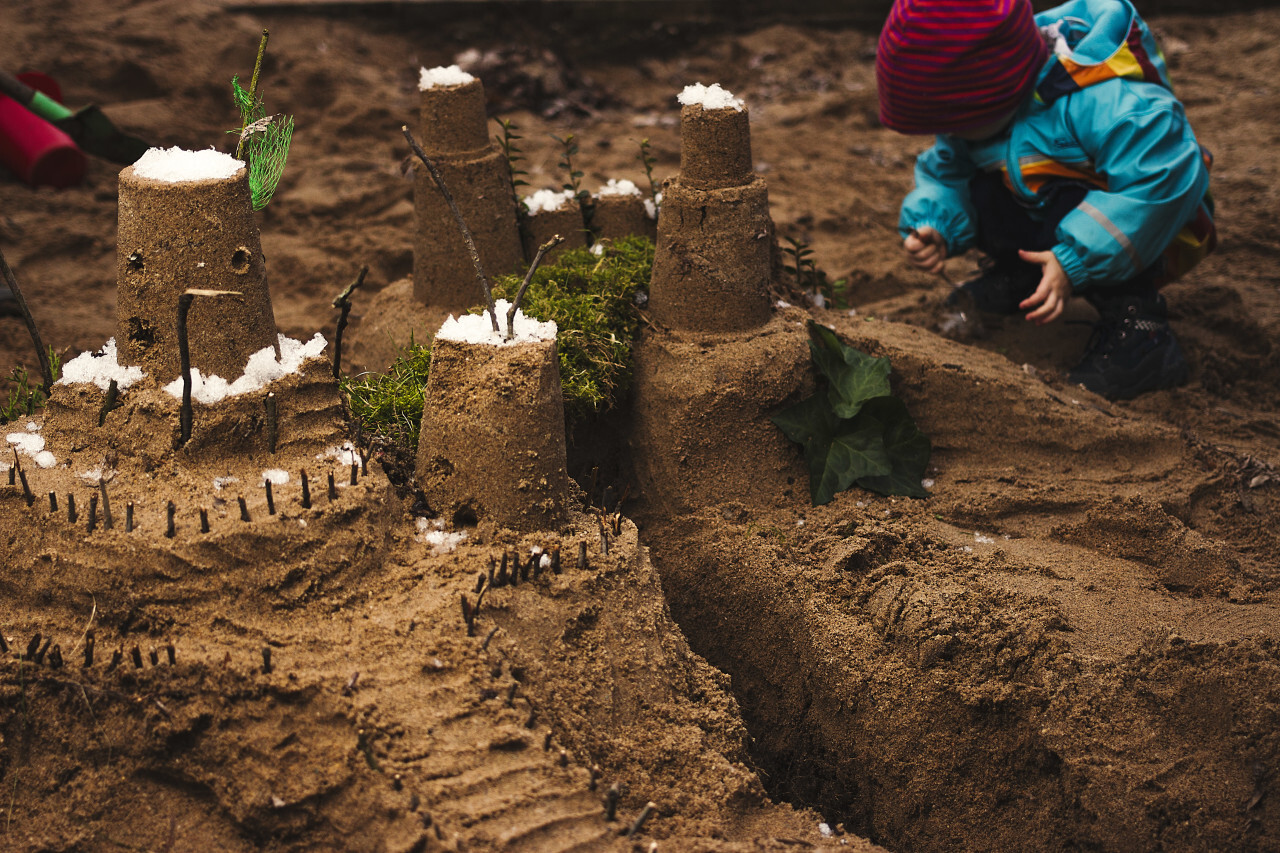 playing with sand building a castle