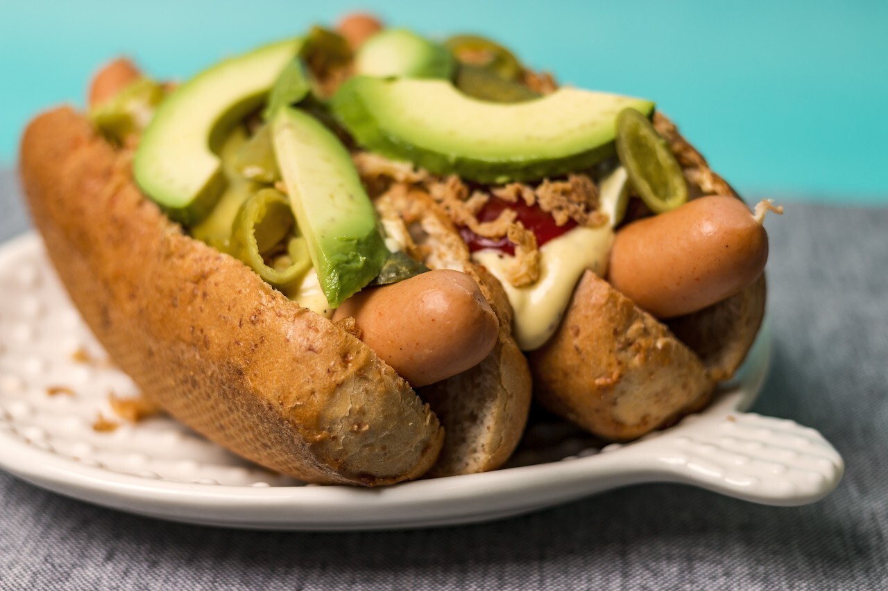 gourmet hot dogs with avocado slices
