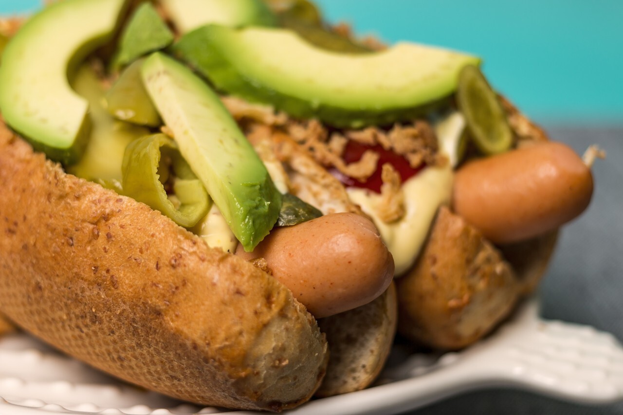 gourmet hot dogs with avocado slices