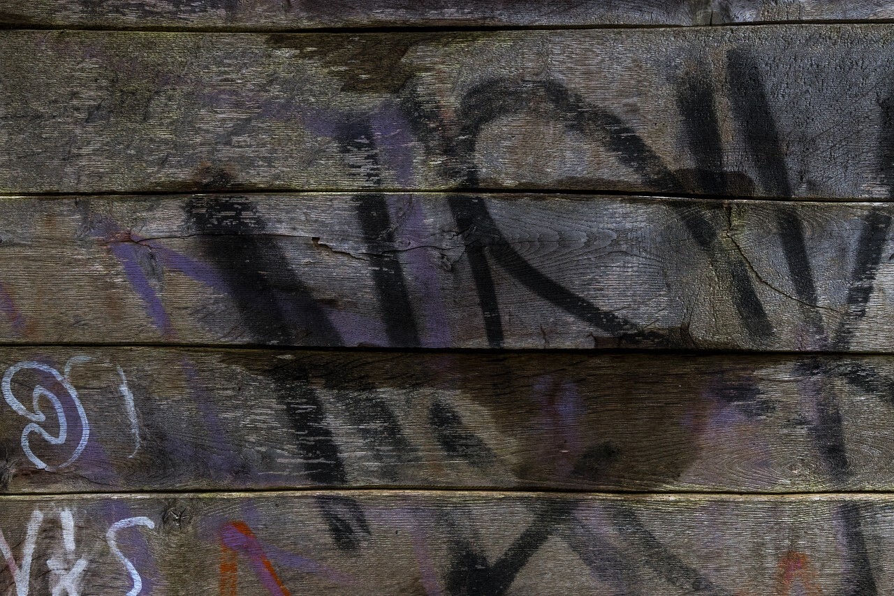 wooden planks smeared with graffiti