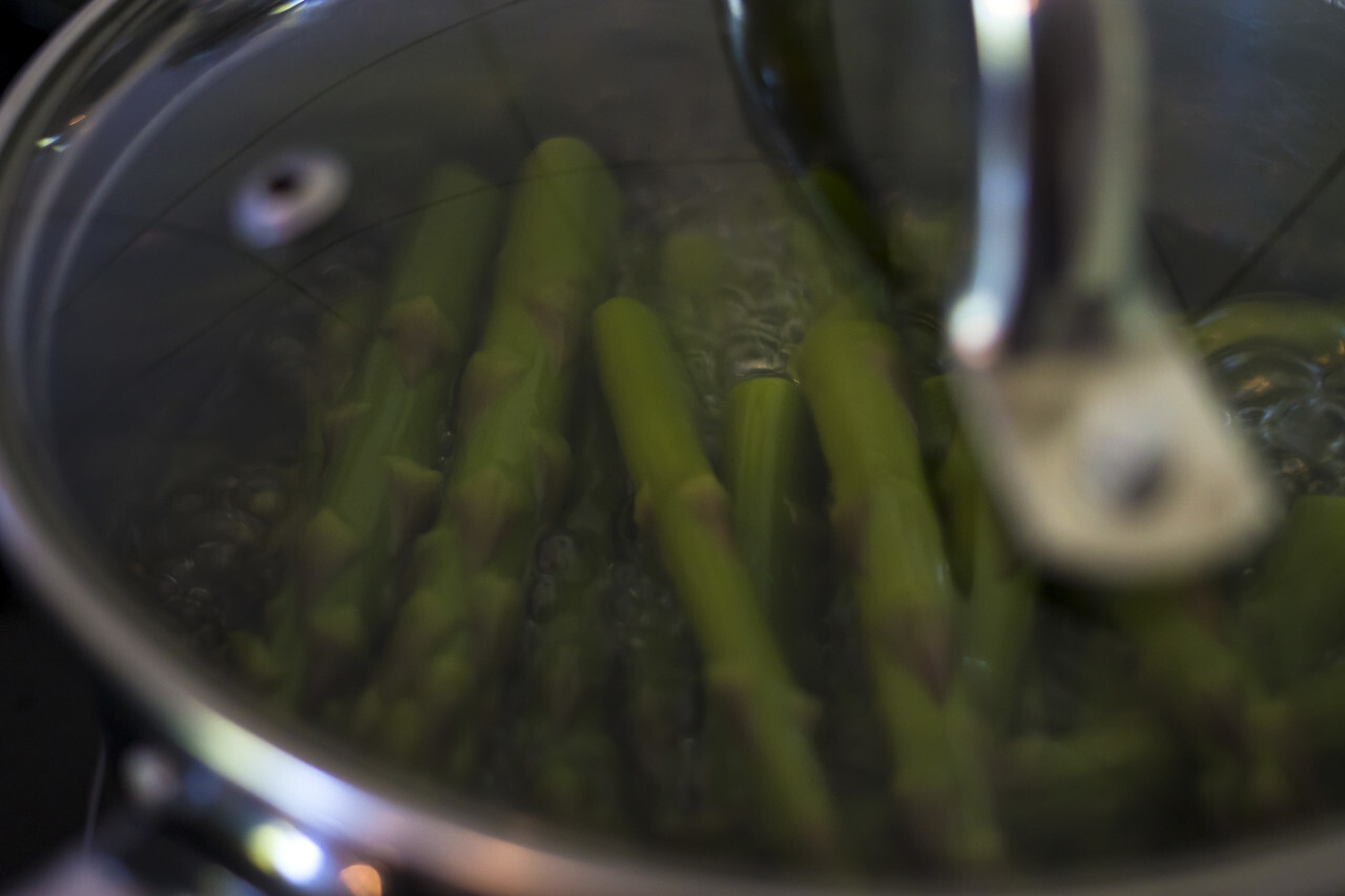 green asparagus cooks in the pot