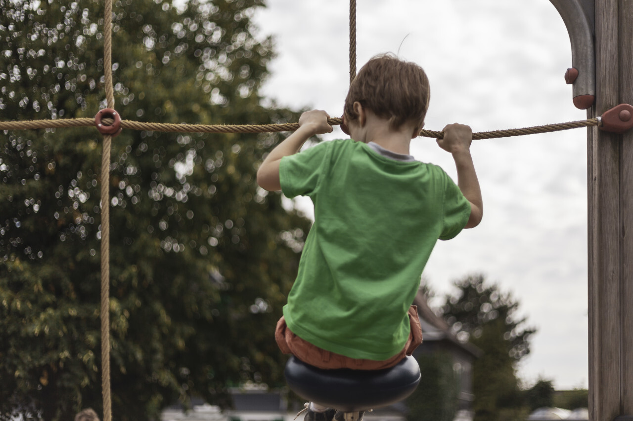 little boy on climbing frame