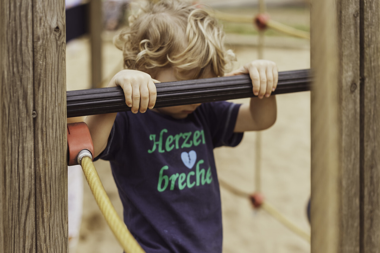 little boy on climbing frame on a playground