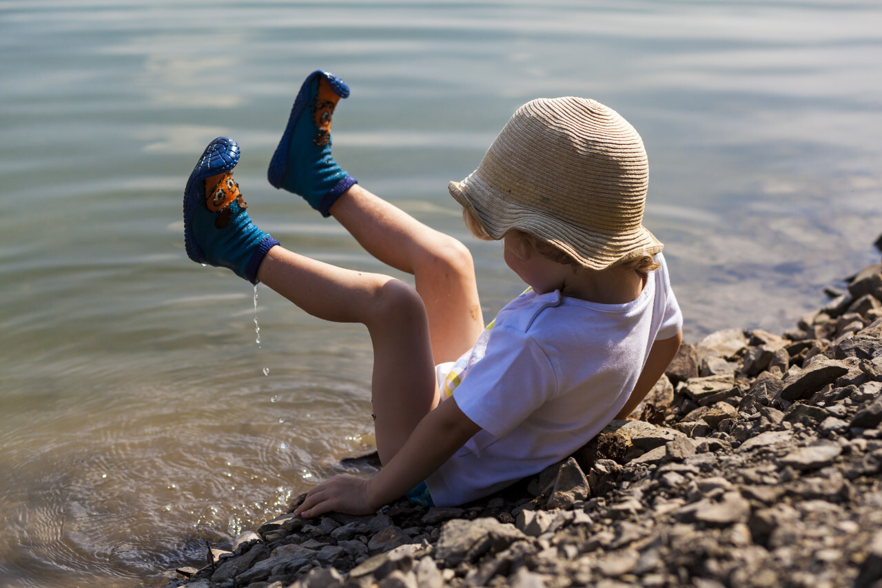 little boy on a lake