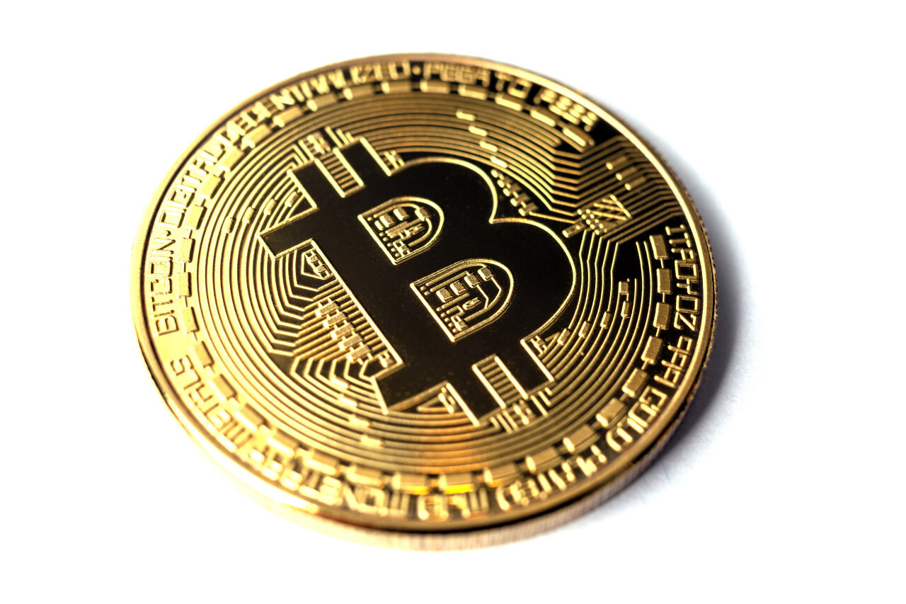 Golden bitcoin isolated on a white background