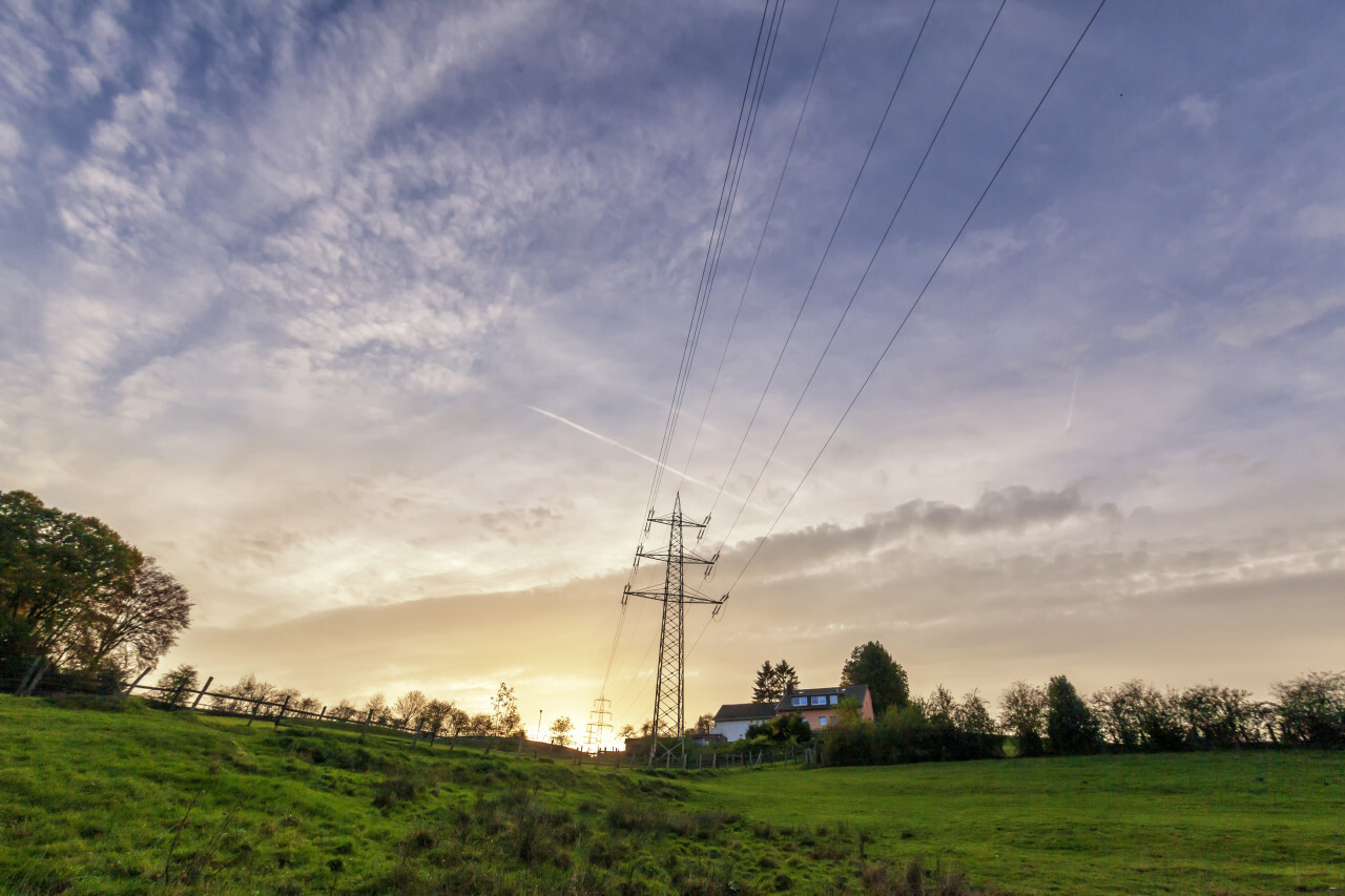 german rural autumn landscape marscheider bachtal in nrw power poles by sunset