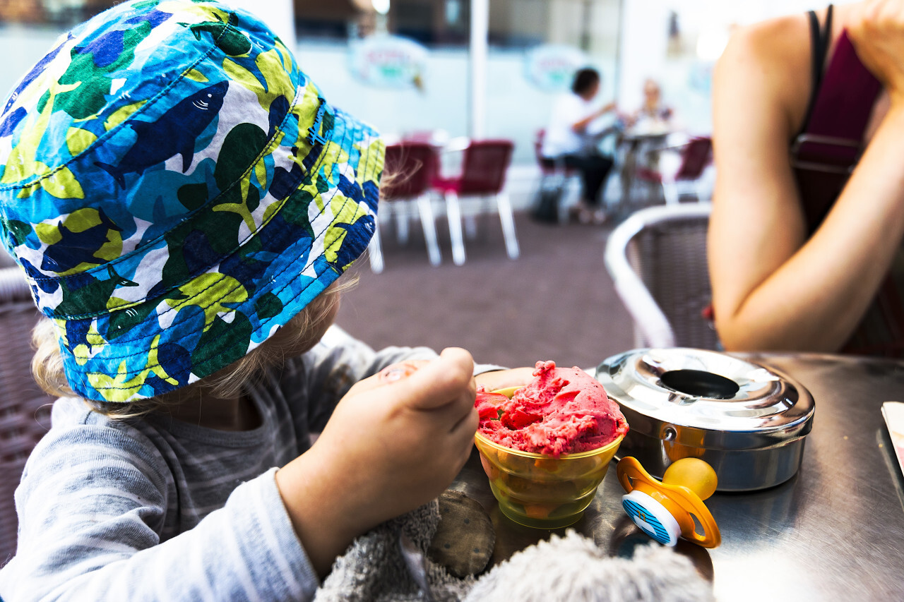 child with strawberry ice cream cup