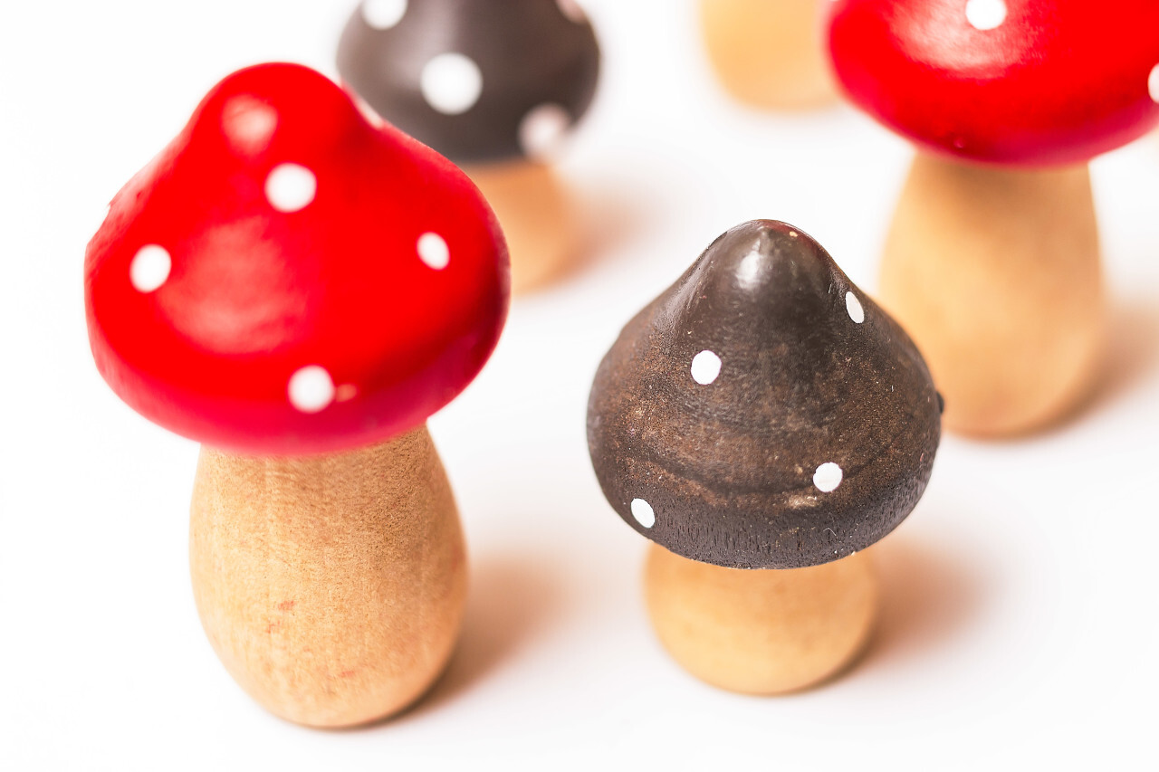 toadstools or fly agaric mushrooms made of wood on a white background