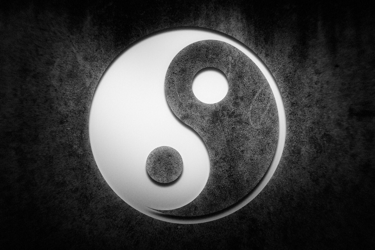 yin and yang on a stone background
