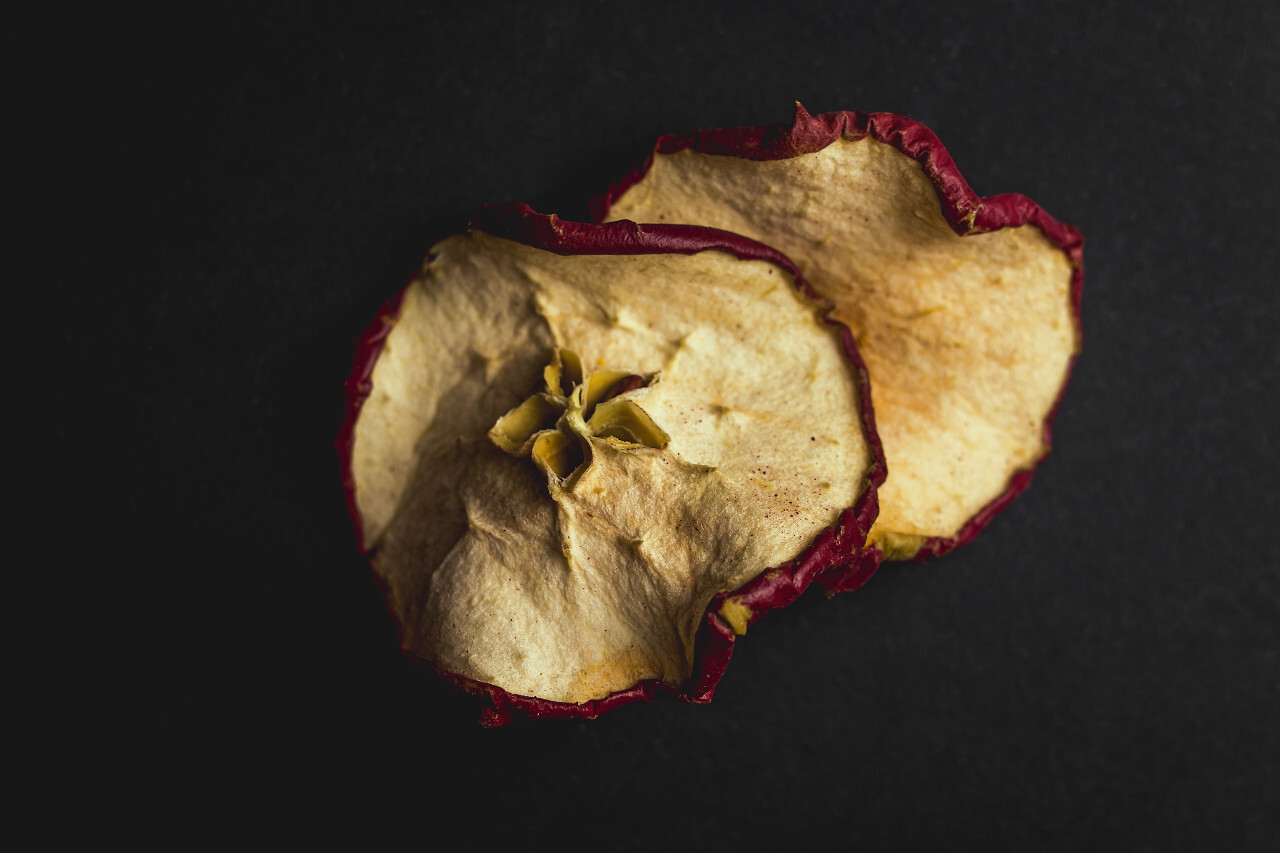 dried apple slices black background