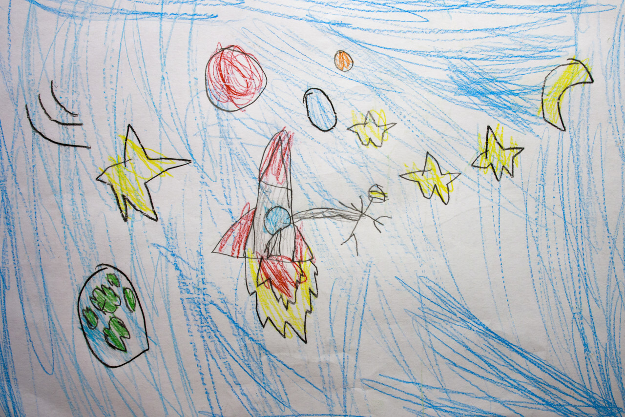 Rocket in space with an astronaut and some planets. Painted by a 6 year old child.