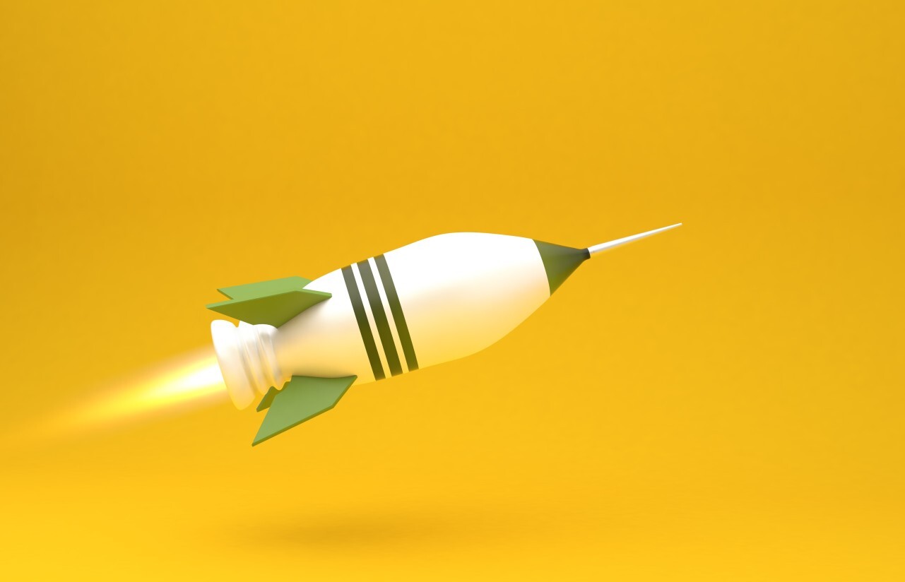 big green rocket on yellow background