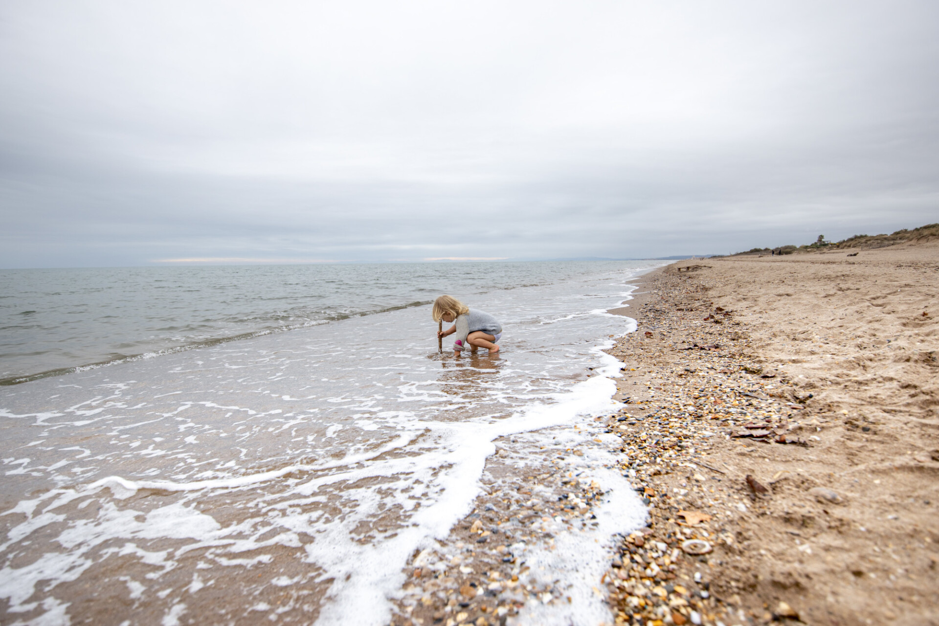 Little girl plays in the sea of Spain