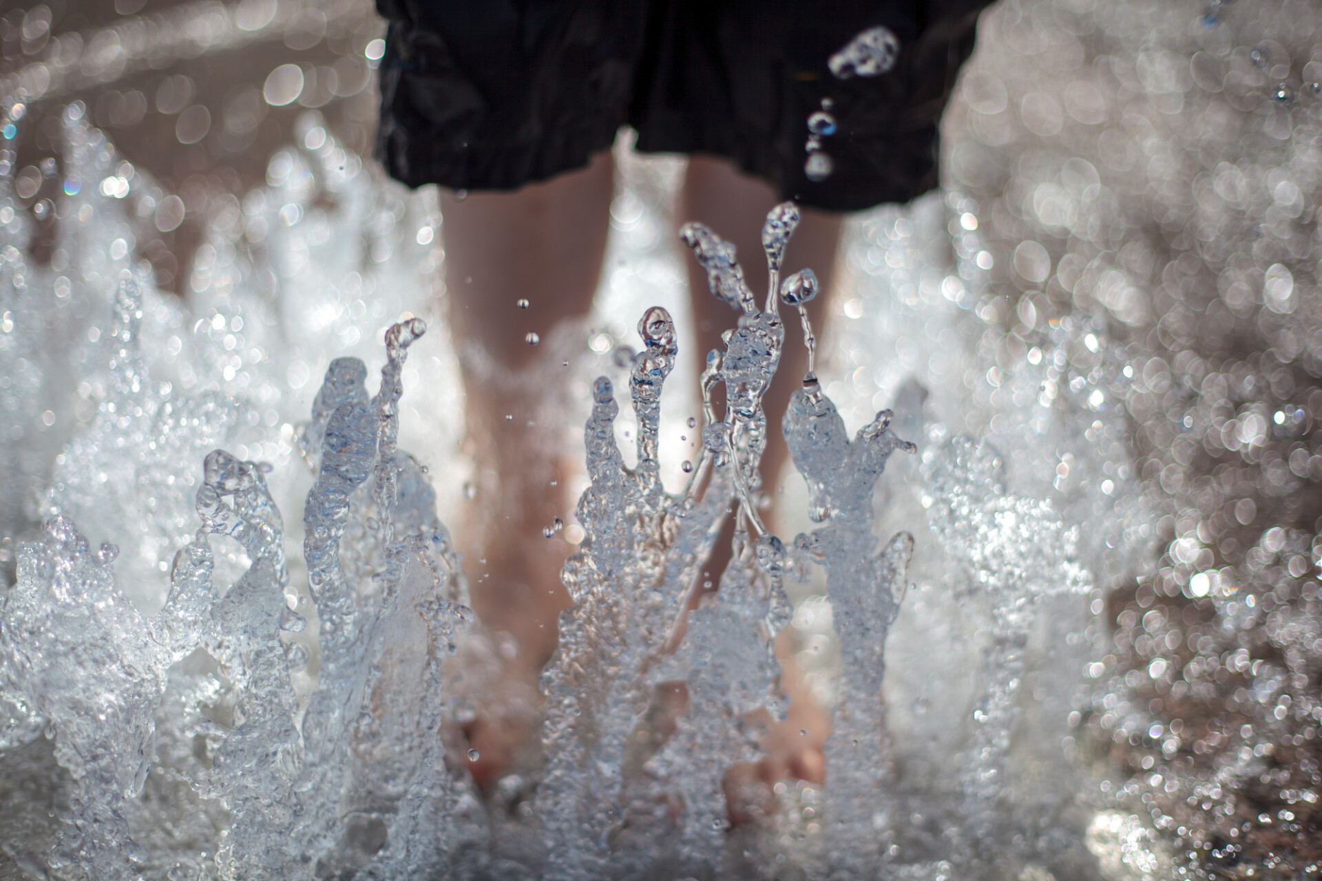 Child with feet in the fountain