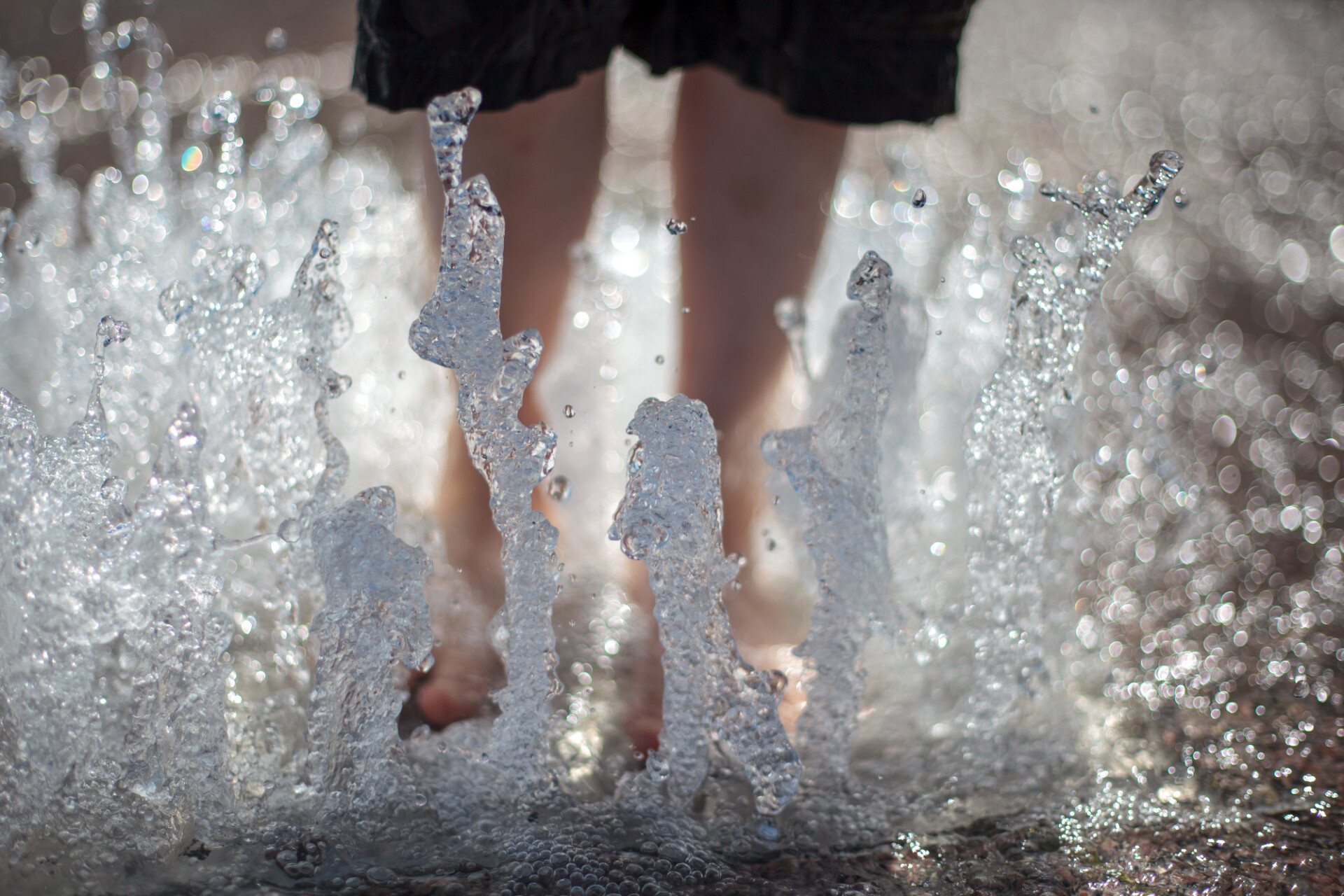 Child with feet in the fountain in Summer