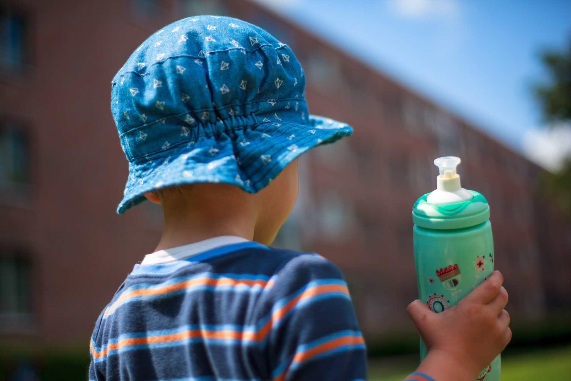 Toddler with plastic water bottle