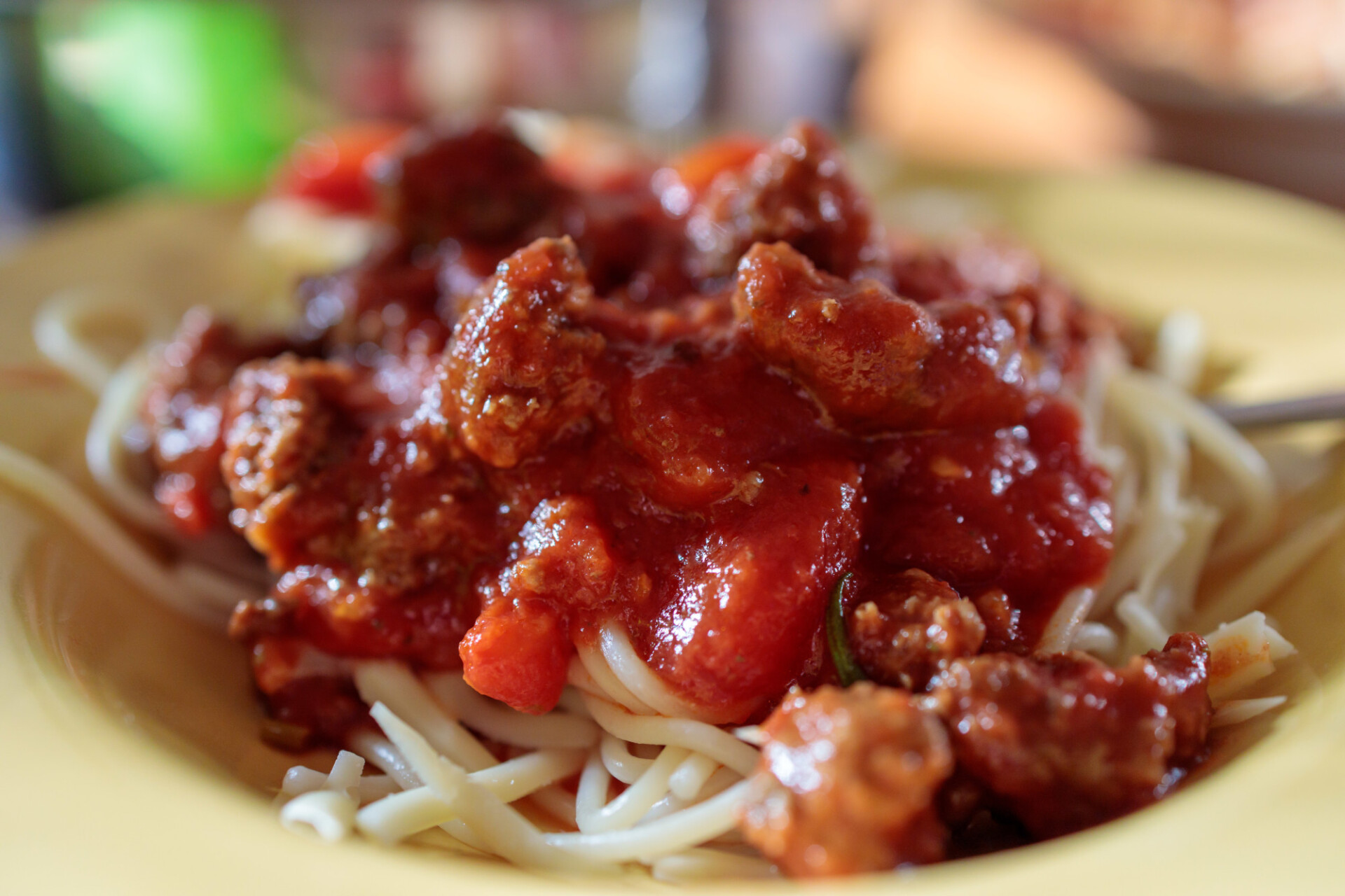 Spaghetti Bolognese on a yellow plate