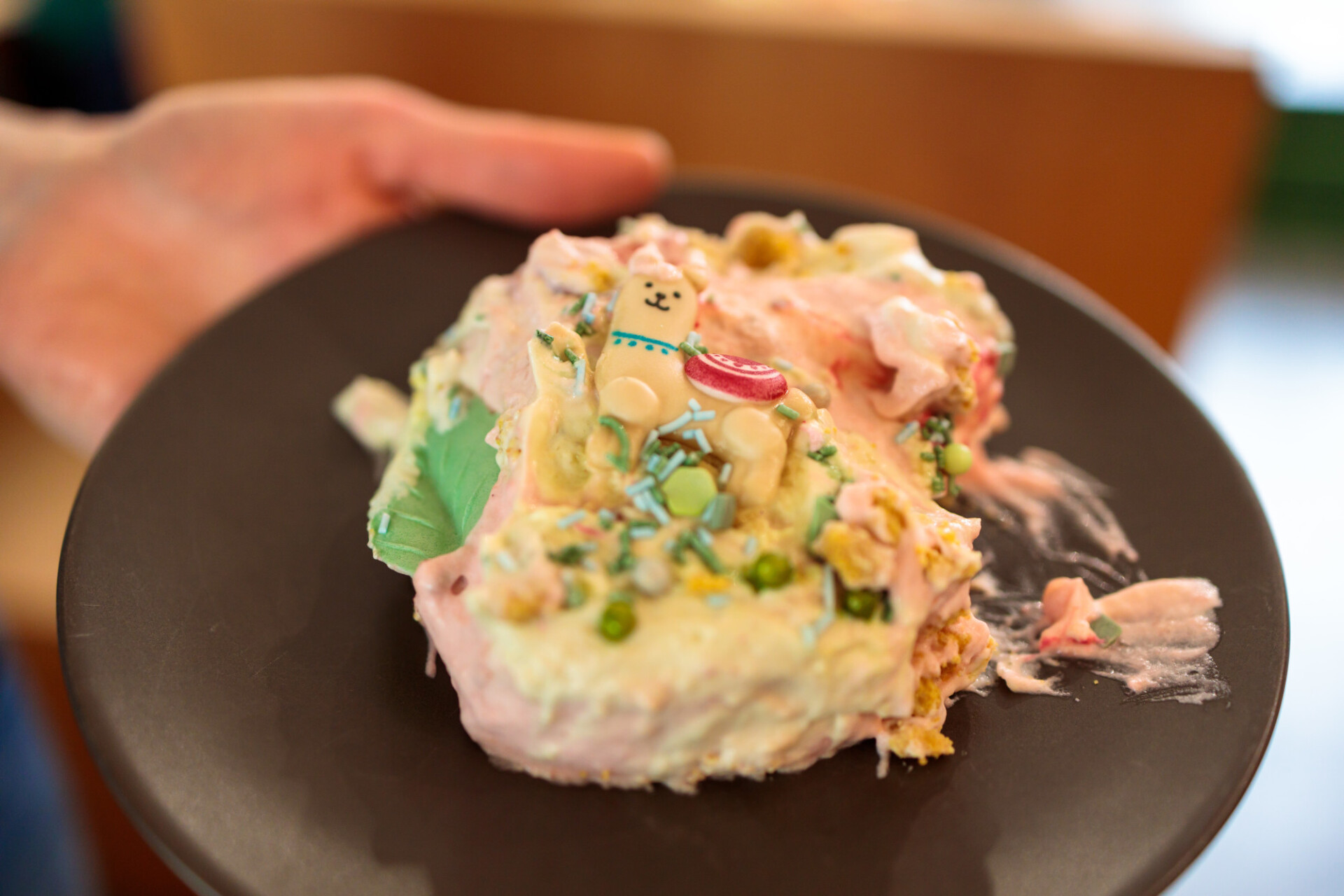 Colourful piece of a children's birthday cake on a plate