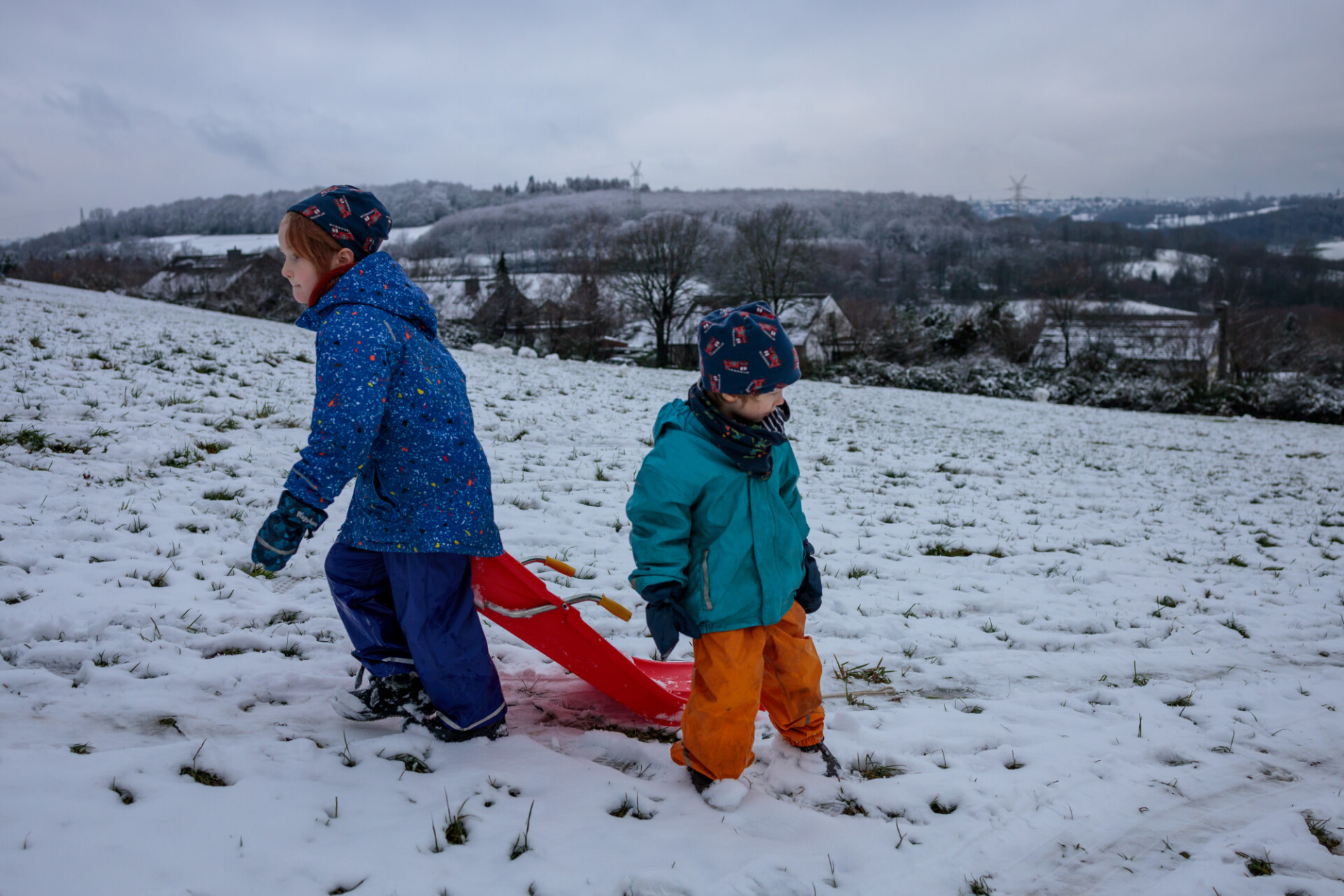 Children pull the sledge up the mountain