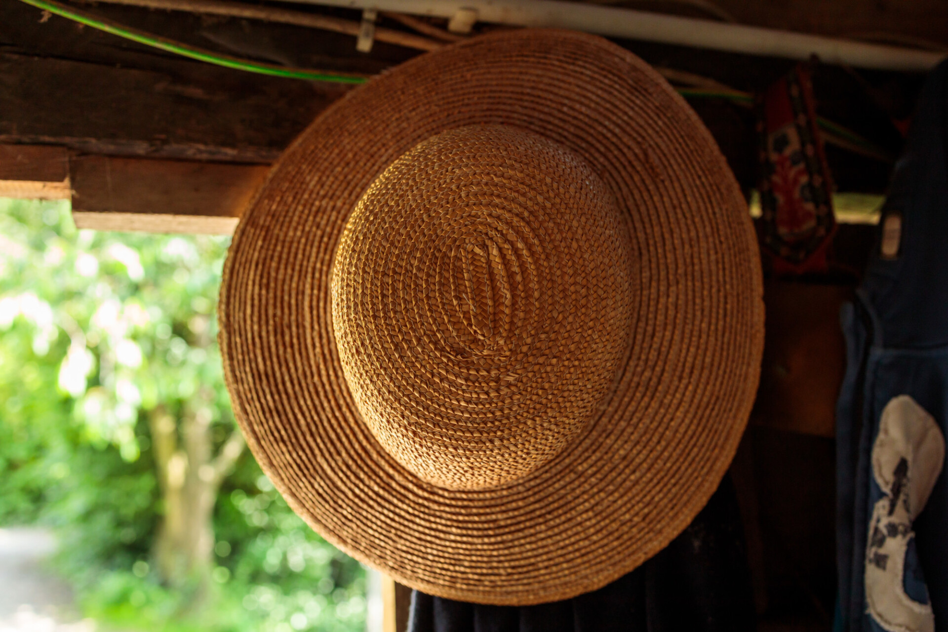 Straw hat hanging in a barn