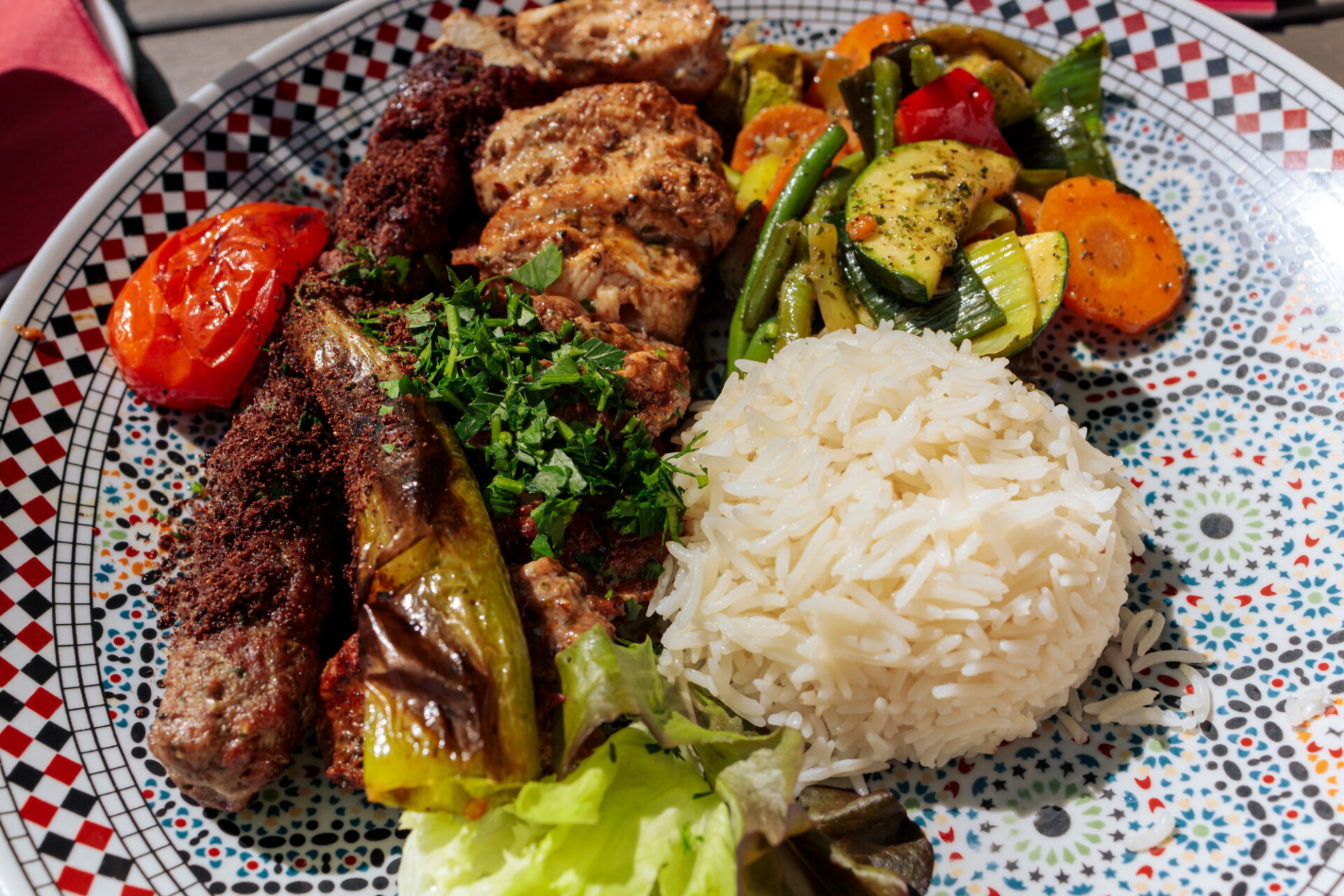 Arabic meat kebabs with rice and grilled vegetables