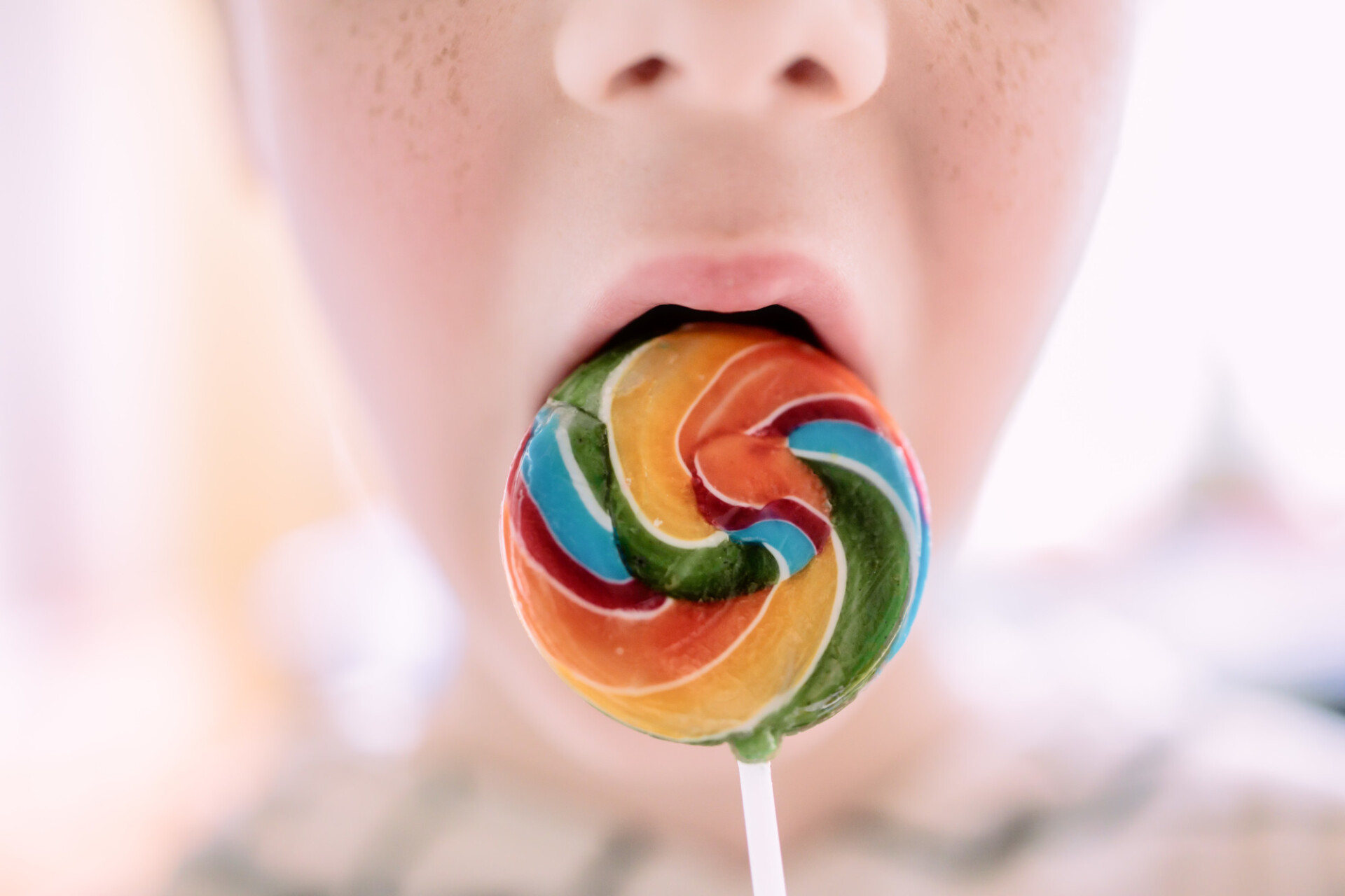 Child with a colourful lolly