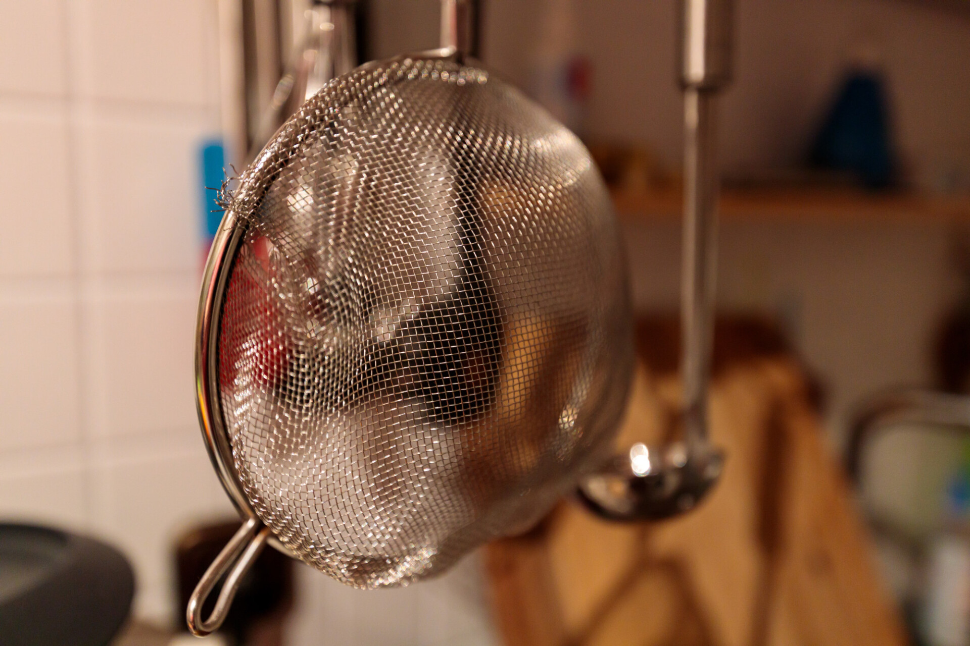 Kitchen colander hanging over the sink