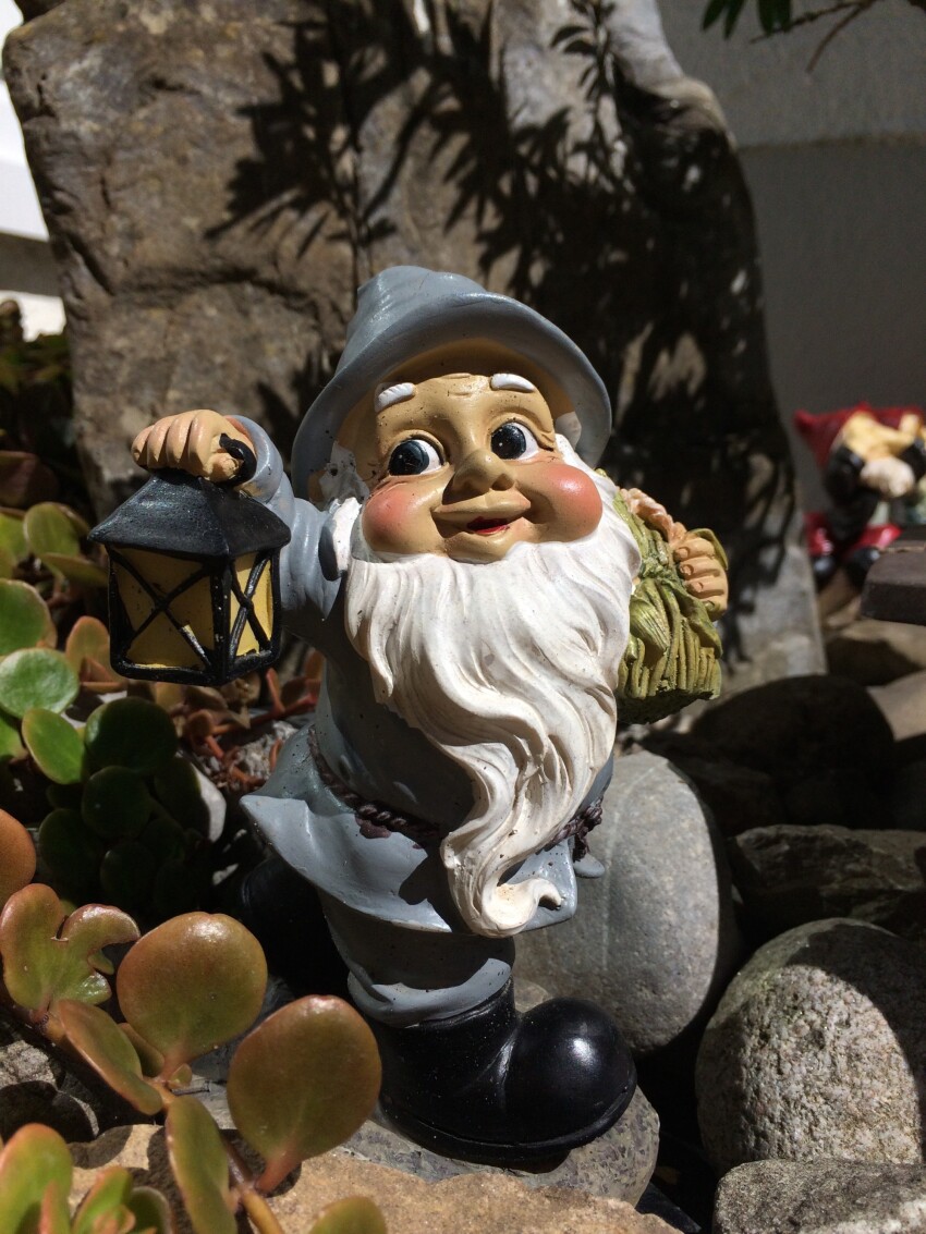 Garden gnome with lantern in hand