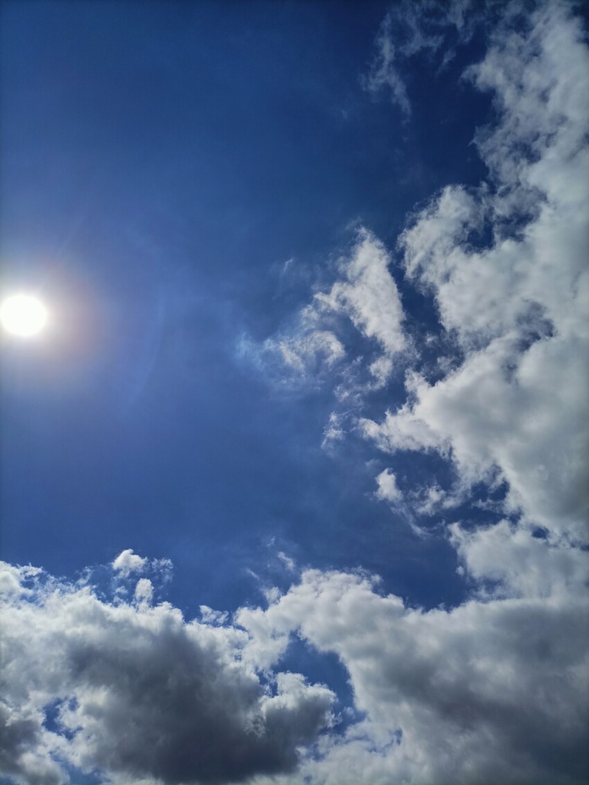 Blue Sky with Sun and Clouds