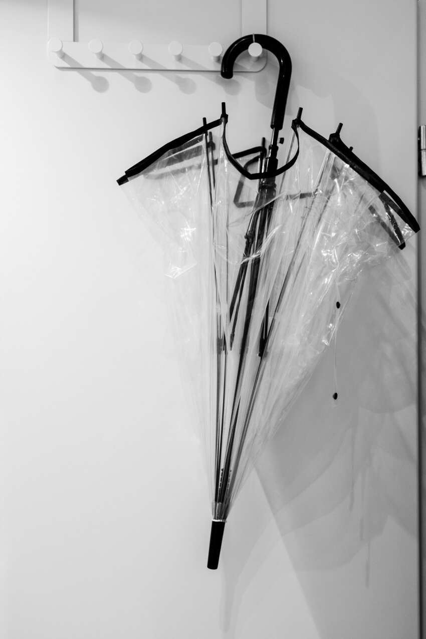 Transparent umbrella hanging on a door