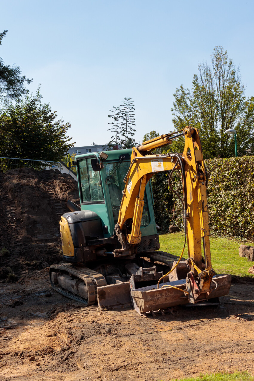 A yellow excavator on a construction site