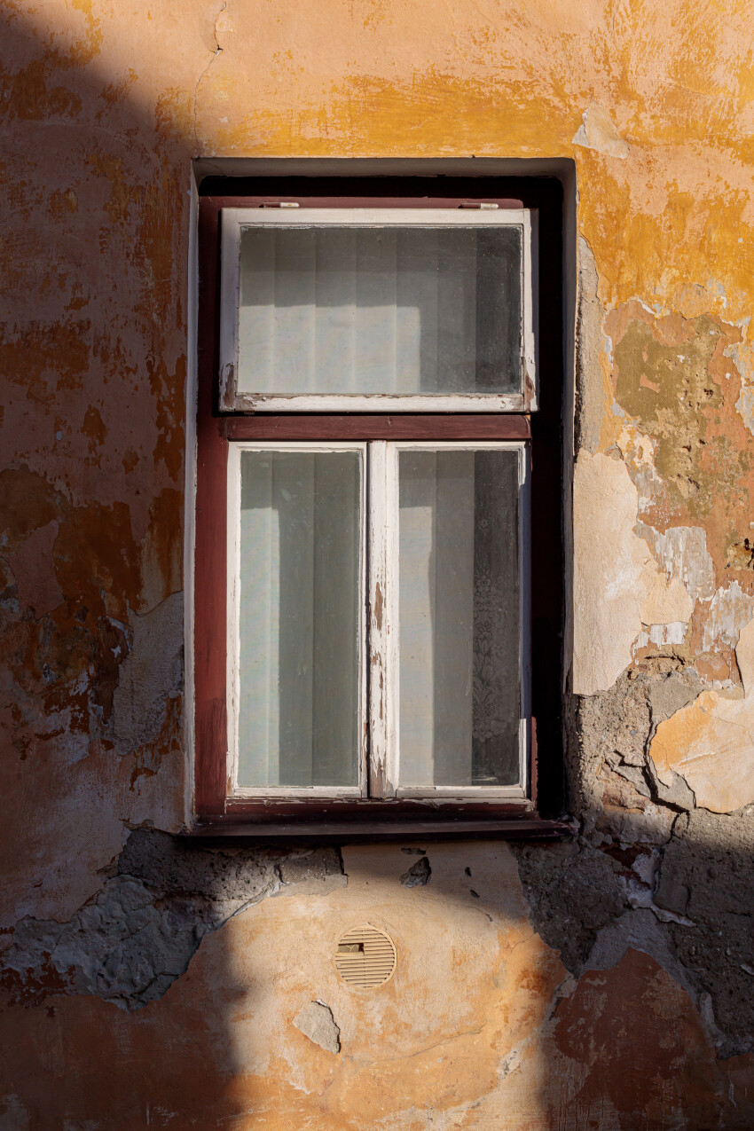 Old window in crumbling wall