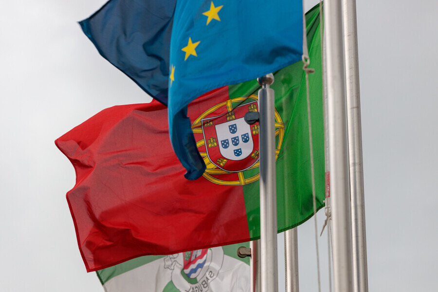 A Symbol of Unity: Portugal Flag and European Flag Waving in the Wind