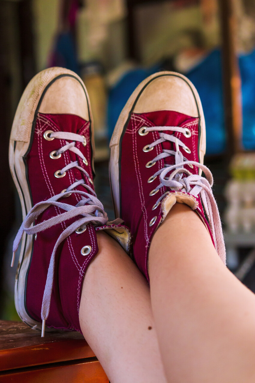 legs of a girl with red chucks