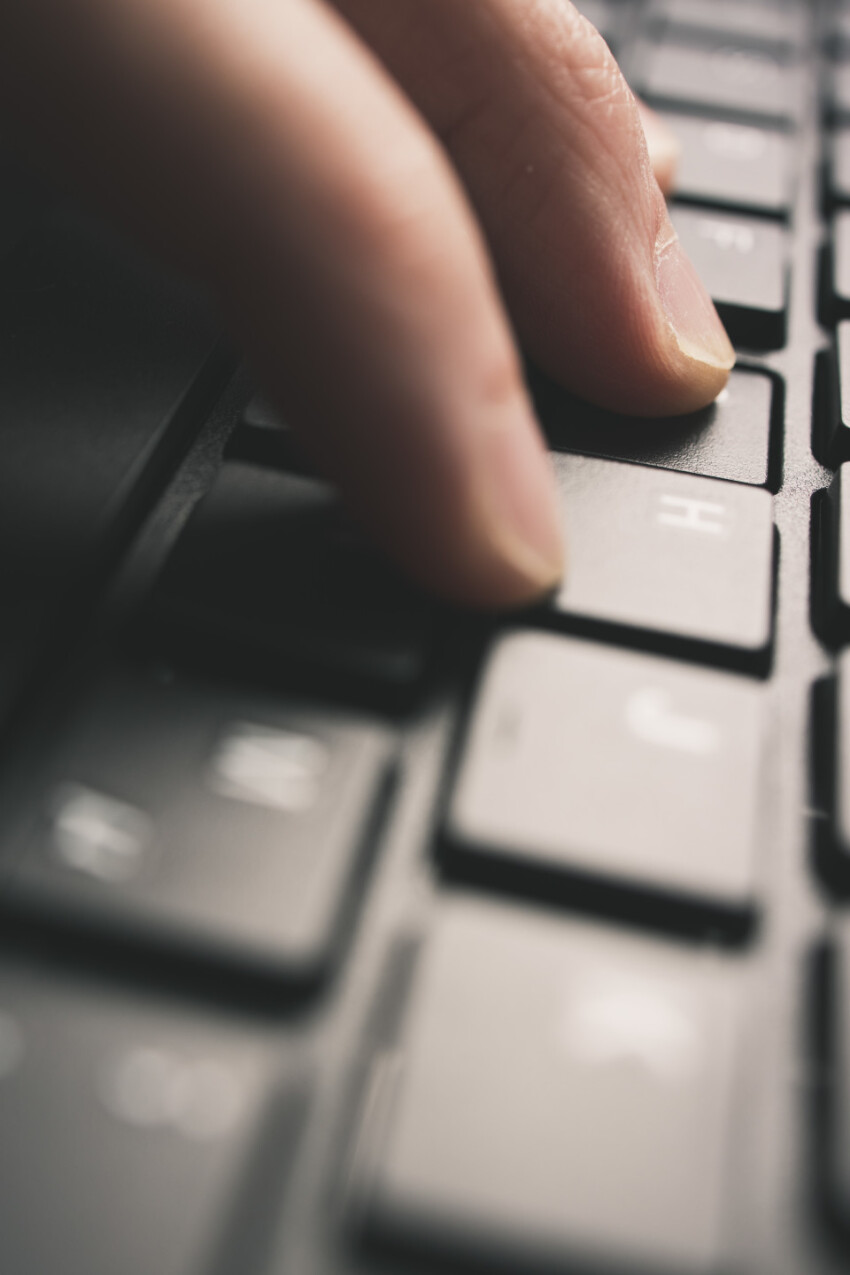 Detailed view of man is tipping on a computer keyboard