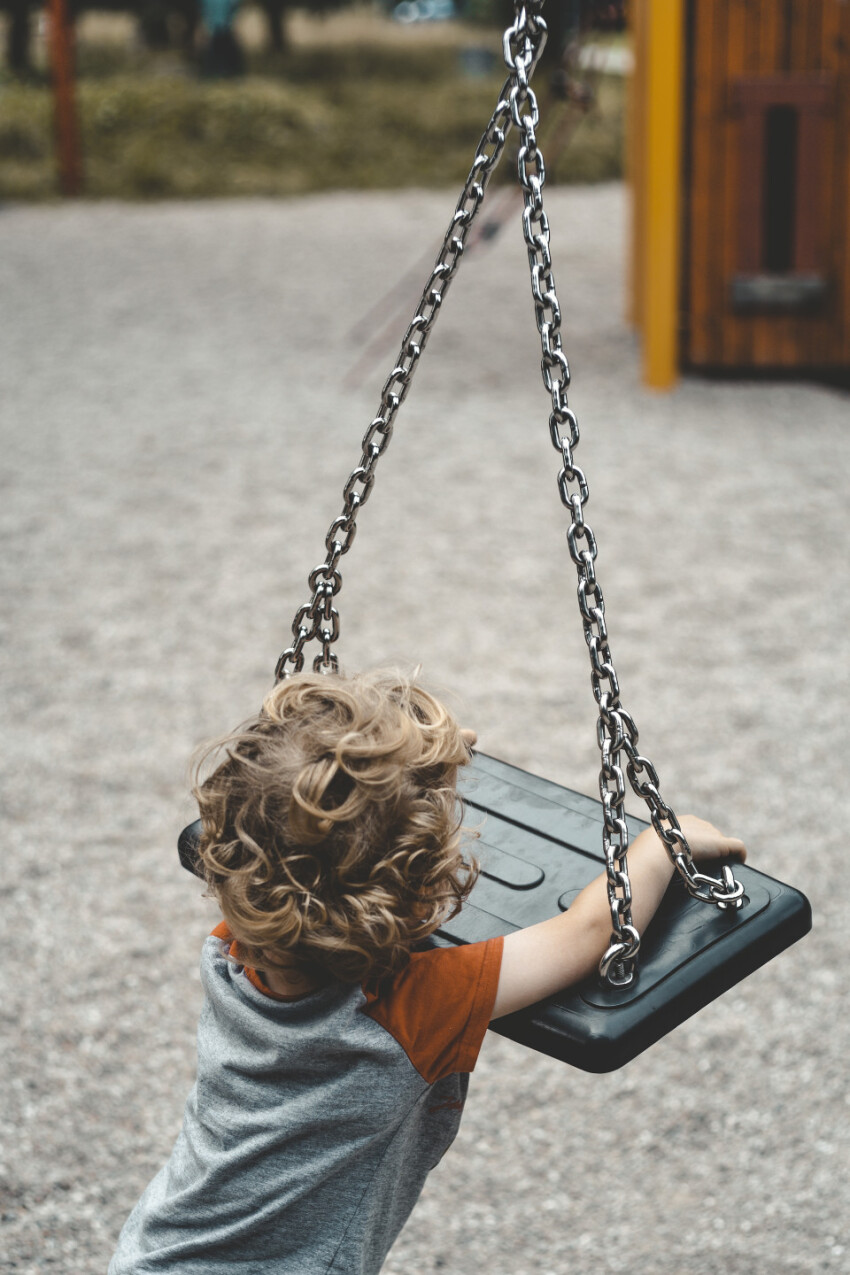 child turns on swing