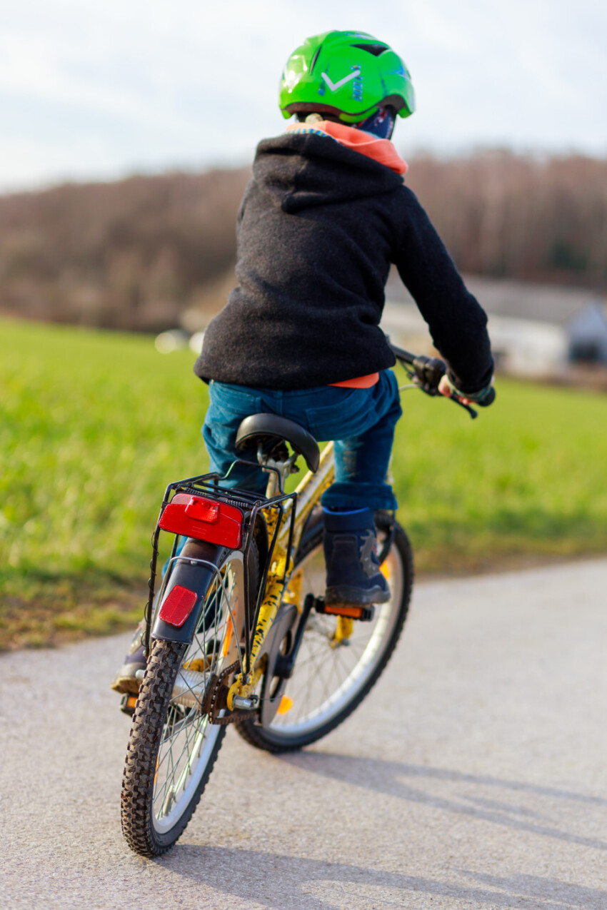 Boy riding bike in a helmet