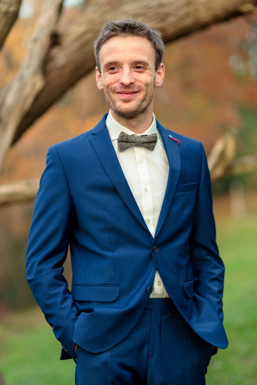 Smiling businessman in a blue suit with a bow tie