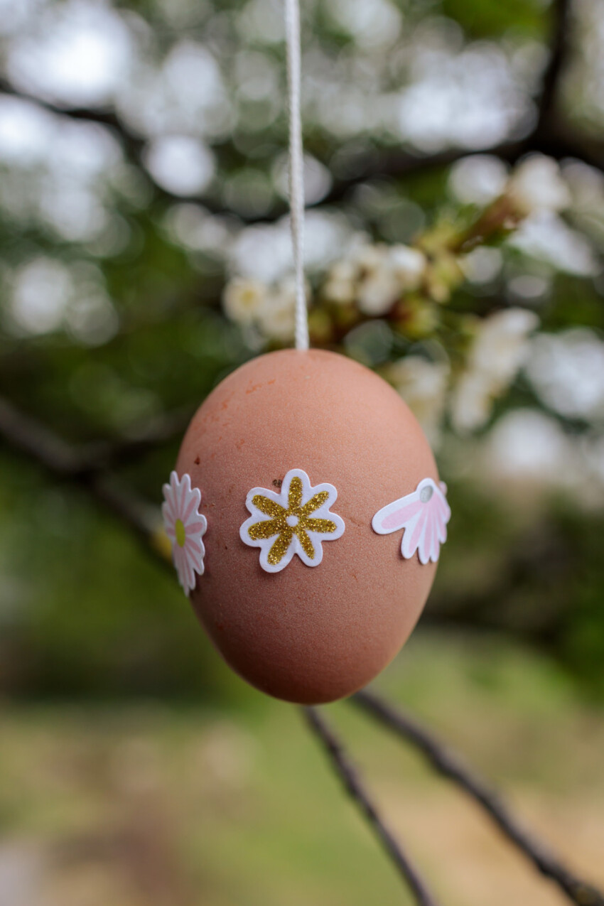 Nicely decorated Easter egg hangs in the garden